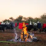 Sundowners around a fire.