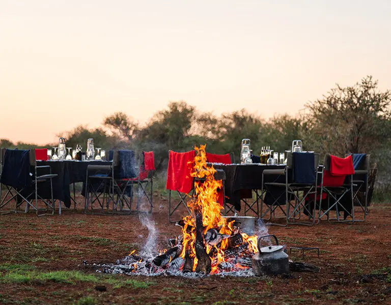 Sundowners around a fire.