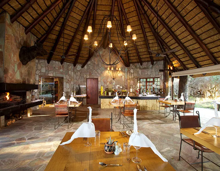 Meals are served in an open-air setting or in the indoor dining area.