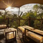 Take in the views from the deck of your luxury tent.