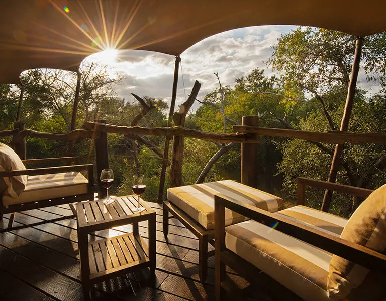 Take in the views from the deck of your luxury tent. 
