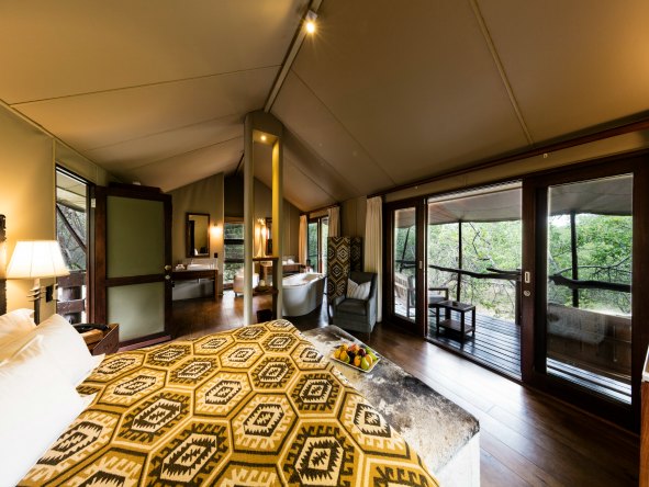 Wooden floors, leather and dark wood furniture create a classic, yet chic safari atmosphere inside the open-plan suites.