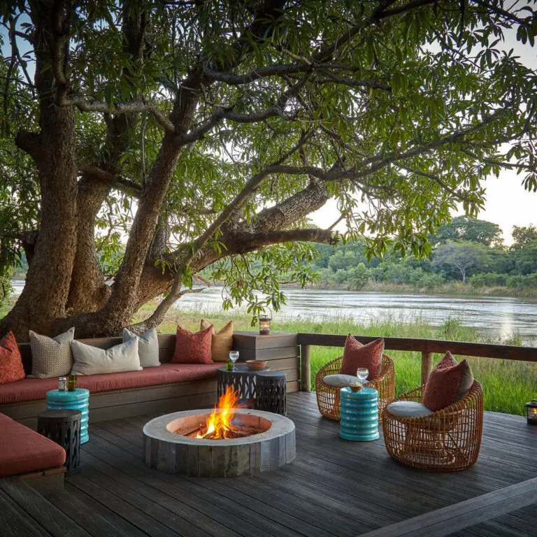 Camp fire on the deck with views of Kapamba River.