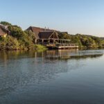 Nestled on the banks of the Bushman’s River, this Lodge is unique in that it connects a Big-5 game reserve to the sea | Kariega River Lodge.
