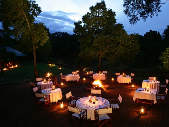 Flickering candlelight under a shower of stars - it's time for supper on a Kenya luxury safari.