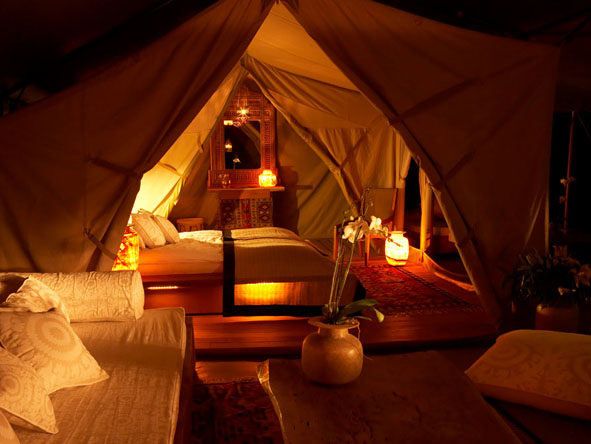 The warm light of candles under canvas creates an unmistakable ambience on a Kenya luxury safari.