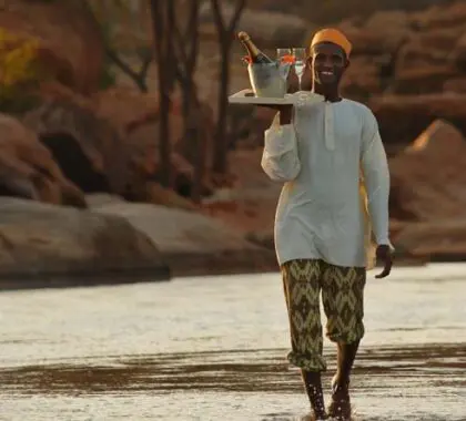 Room service at one of Kenya's top lodges! Sundowner drinks served at the river.