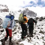 The final ascent takes place in snowy and rocky conditions. Make sure your boots are equipped for the job!