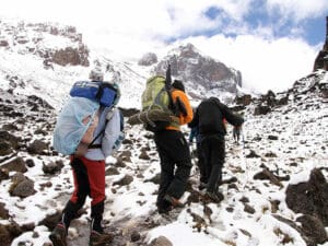 The final ascent takes place in snowy and rocky conditions. Make sure your boots are equipped for the job!