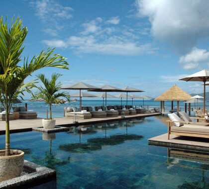 The resort's sea-facing swimming pool with shaded loungers.