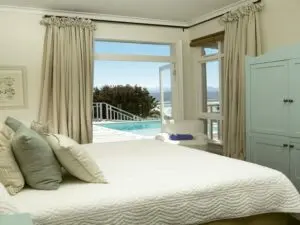 The comfortable bedroom opens up onto the deck and pool side.
