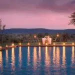 Dine under the stars next to a sparkling swimming pool.