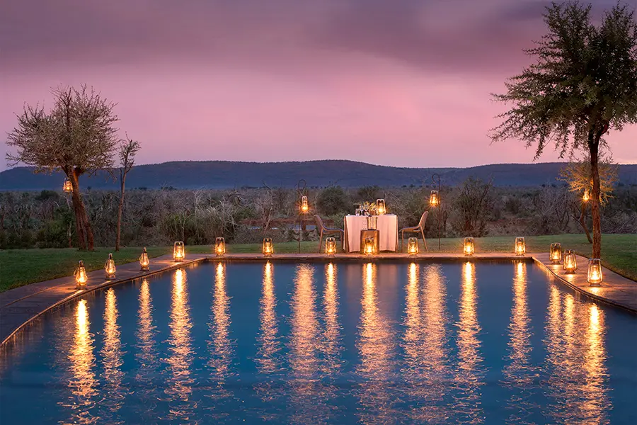 Dine under the stars next to a sparkling swimming pool.