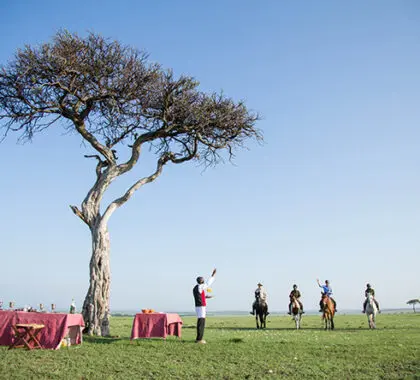 Guests are welcomed back with a refreshing beverage after a day of horse riding in the Mara.