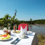 Get ready for a surprise or two: morning drives often end with breakfast next to the Mara River.