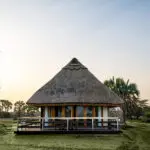 A tented suite, built on a wooden deck and shaded by a thatched roof which naturally helps to controls the temperature. 