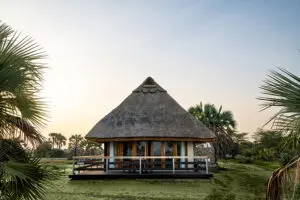 A tented suite, built on a wooden deck and shaded by a thatched roof which naturally helps to controls the temperature. 