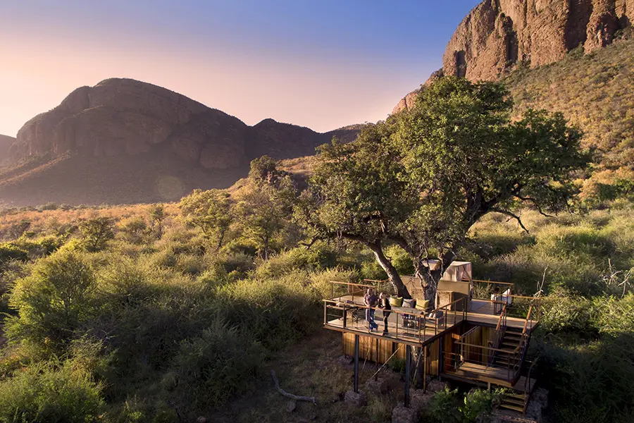 Book a night at the Thabametsi Treehouse - a raised platform set up like a suite, including an en-suite.