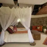 Draped mosquito nets assure a good night's sleep at Mbweha Safari Camp.