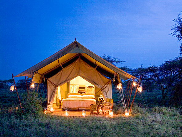 Your lamp-lit tented suite makes a welcome sight on your return from a day's game viewing.