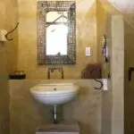 The large bathroom has a big window and the shower offers views into the surrounding bush