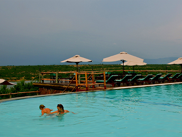 The large swimming pool in front of the lodge provides cooling relief from the hot African sun.
