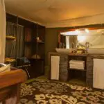 En suite bathrooms feature twin vanities, flush toilets and solar-powered bucket showers.
