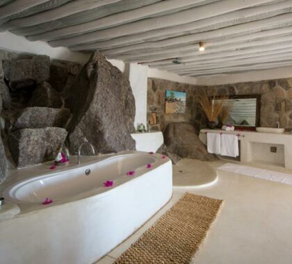 The gorgeous en-suite bathrooms have stylish bathrtubs carved out of rock and marble.