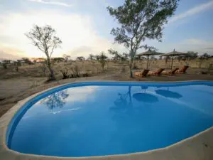 A large swimming pool provides the opportunity to cool off and bask in the dazzling African sun.
