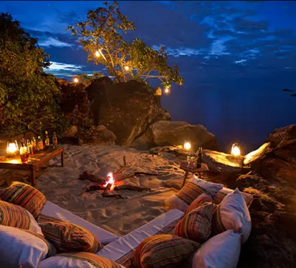 Candles & campfires compete with starlight at Malawi's Nkwichi Lodge.
