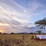 Meals are often served al freco at Nyasirori Tented Camp, an unforgettable safari experience.
