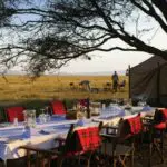 An outdoor dinner in winter with thick Maasai blankets to ward off the high country chill.
