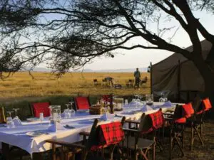 An outdoor dinner in winter with thick Maasai blankets to ward off the high country chill.
