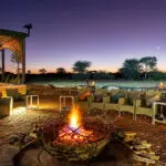 An evening around the fire and undetr the stars at Okonjima Plains Camp.
