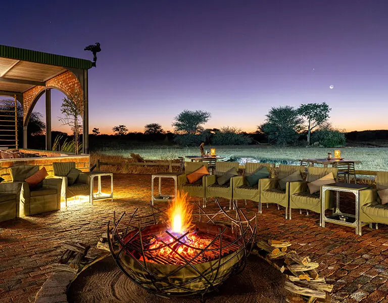 An evening around the fire and undetr the stars at Okonjima Plains Camp.