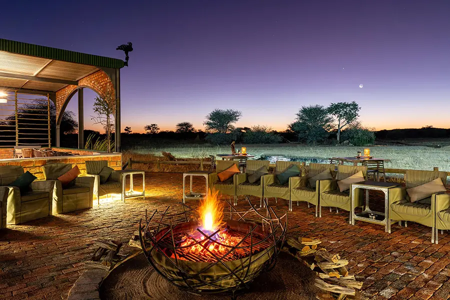 An evening around the fire and undetr the stars at Okonjima Plains Camp.