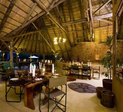 The main dining area is warm and cosy under thatch, with open-air views.