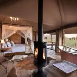 Estufa de leña y bañera exenta en el salón.