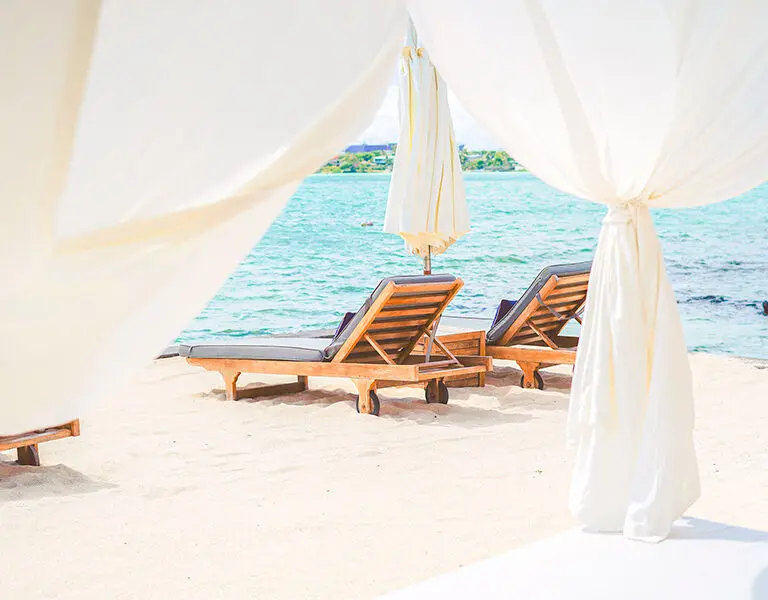 Comfortable loungers line the beach.