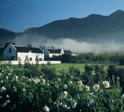 This charming guest house is set on a farm against a beautiful mountain backdrop.