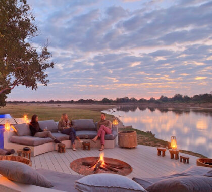 End the day at Chinzombo with fireside drinks & a Luangwa sunset.