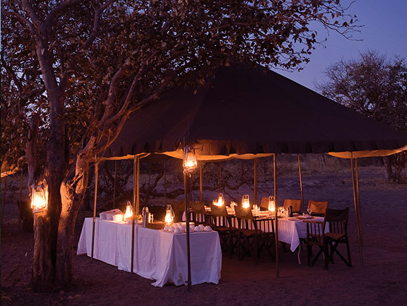 A candle-lit mess tent replaces the train's dining car when you are on safari.