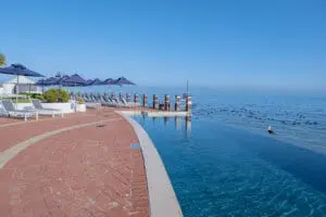 A large pool terrace containing a rim-flow swimming pool.