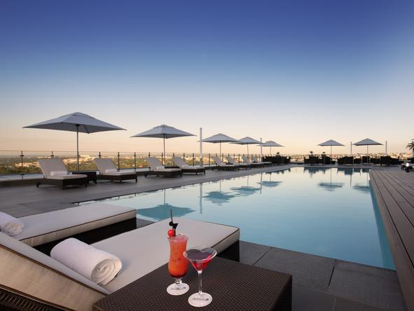 Indulge in a few fruity cocktails while reclining on the plush poolside sunbeds