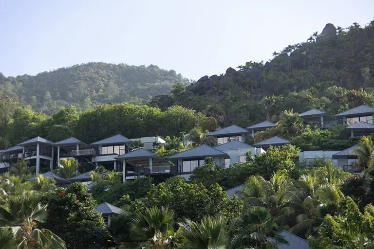 Villas nestled on the lush green hillside.