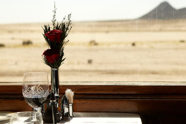 Dine as you pass through the desert on Rovos Rail. 