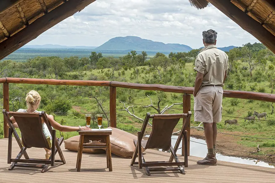 Two people looking over the view from Royal Madikwe's clubhouse | Go2Africa