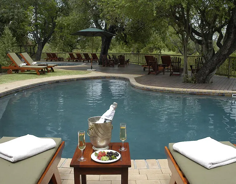 Relax around the swimming pool at Sabi Sabi Bush Lodge.