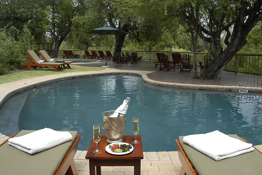 Relax around the swimming pool at Sabi Sabi Bush Lodge.