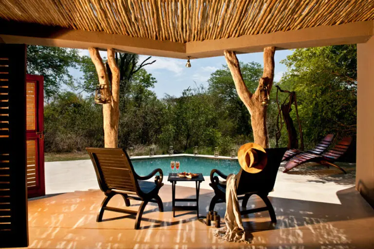 Relax around the swimming pool at Sabi Sabi Bush Lodge.